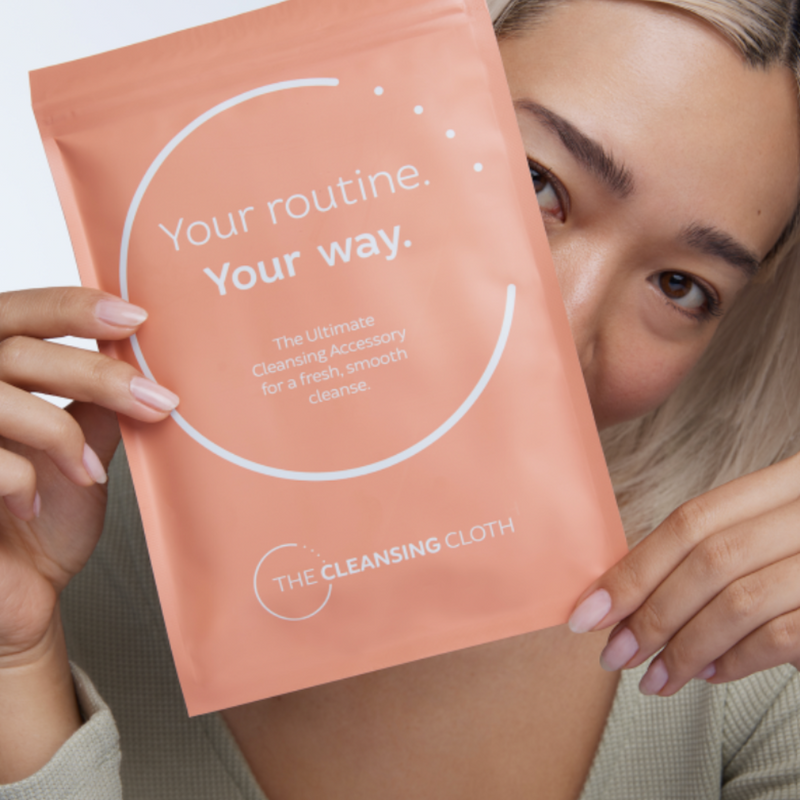 Model using The Cleansing Cloth to wash her face