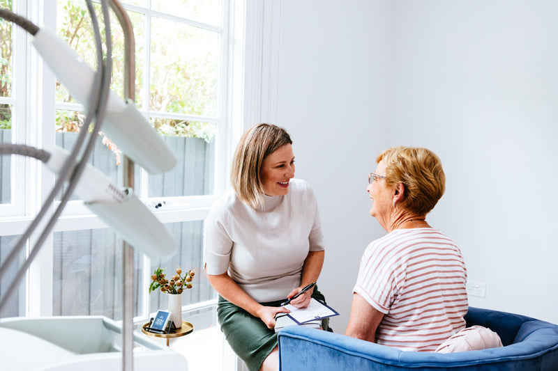 Skin Nerd talking to a client in her treatment room discussing a skin consult